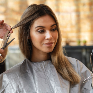 beautiful-woman-getting-her-hair-cut-home-by-hairstylist